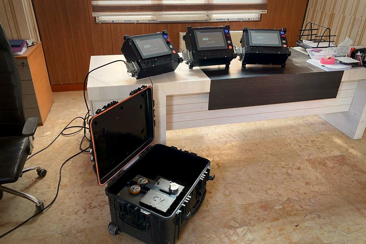 The unit inside its rugged transport case, with the accessory compartment.